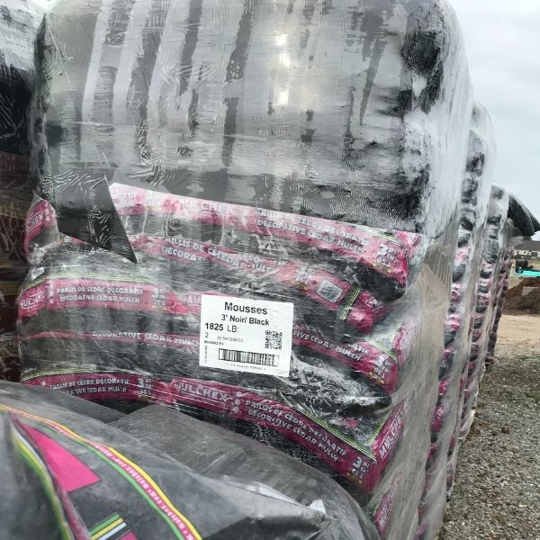pallet with bags of of black cedar mulch at the Bay Landscaping nursery