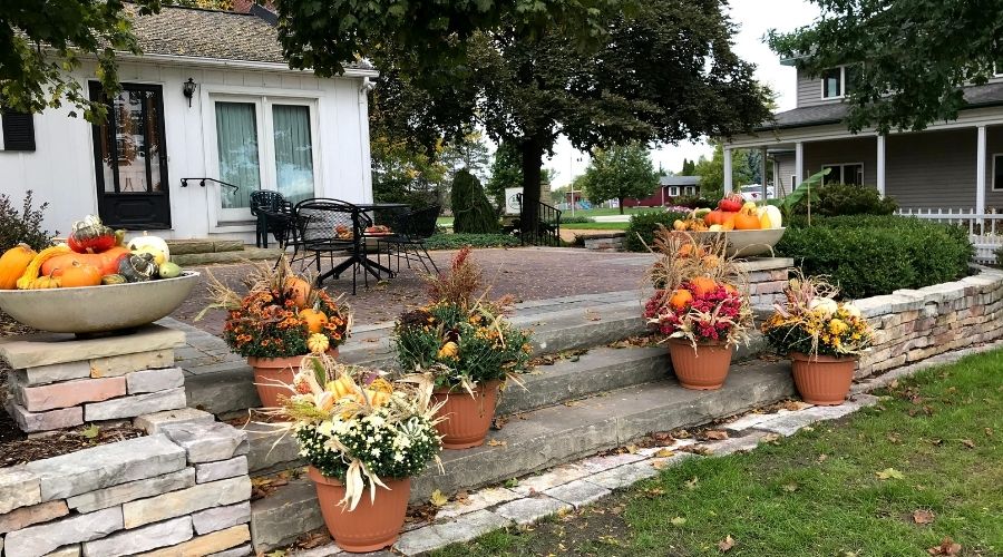 Planters filled with plants and decor suited for fall weather in Michigan.