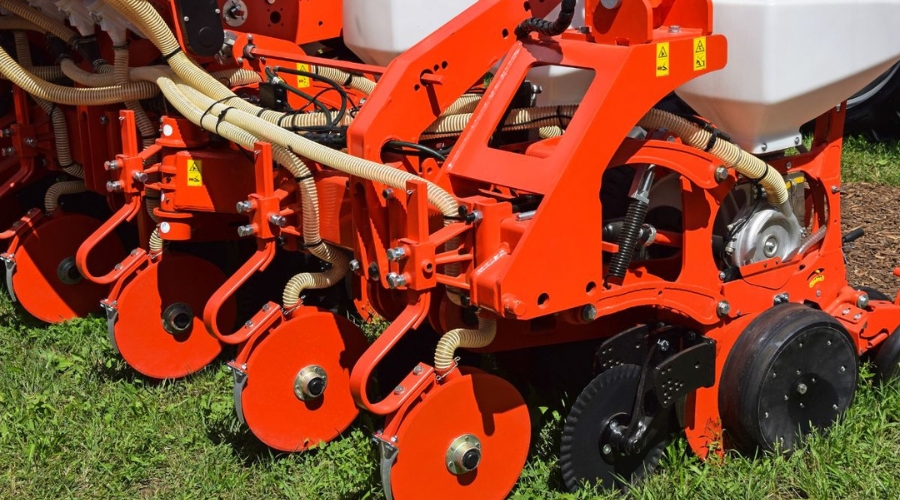 Professional slit seeding overseeder equipment used by Bay Landscaping for fall lawn seeding projects in Great Lakes Bay Region.